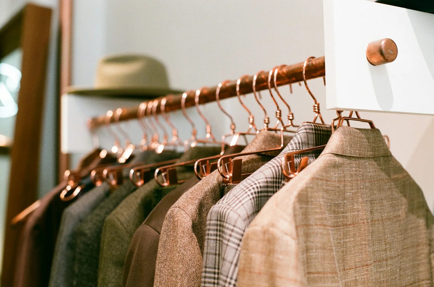 Collection of tailored jackets on wooden hangers